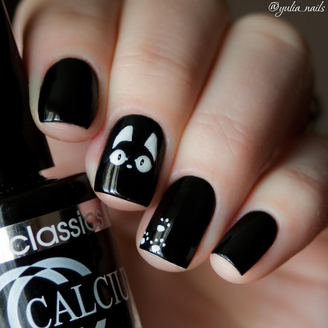 black nail design with white cats