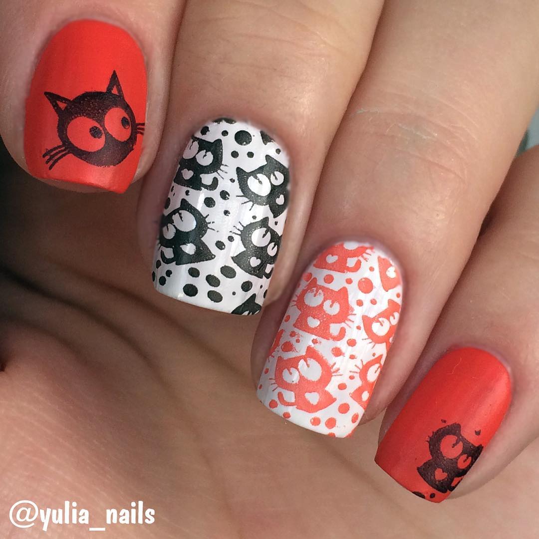 white and red nail design with cats