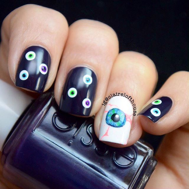 white and black nail design with eyes