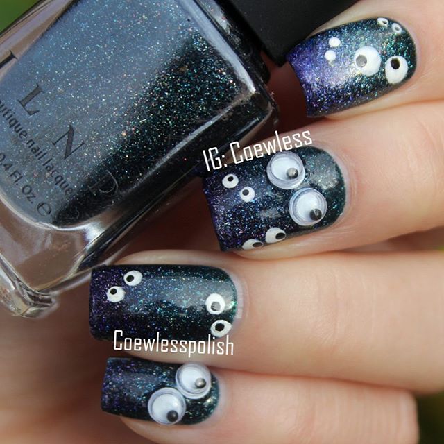 black Halloween nail design with eyes