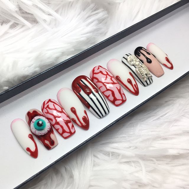 fake nails with blood and an eye