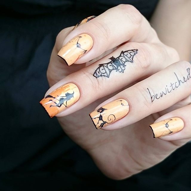 светло-оранжевый маникюр с ведьмами и татуировкой на пальцах