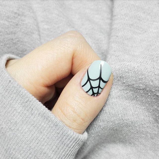 light pastel gray nails with spider web