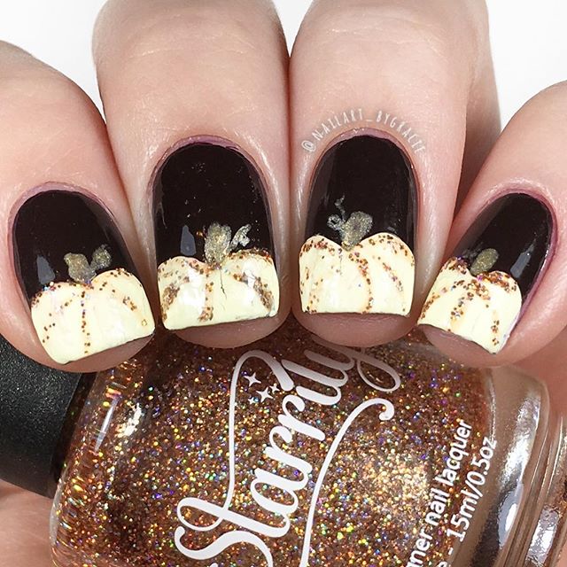 black Halloween nail art with white pumpkins