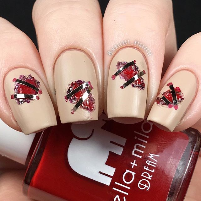 halloween nail design with stitches