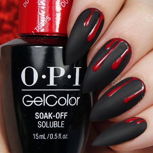black nail design for halloween with red blood drops