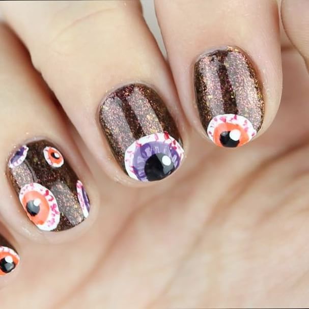 brown nail design for Halloween with eyes